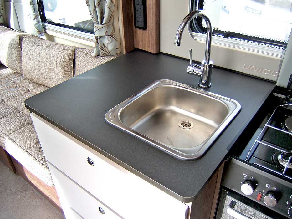 The inset, stainless steel sink with single mixer tap.